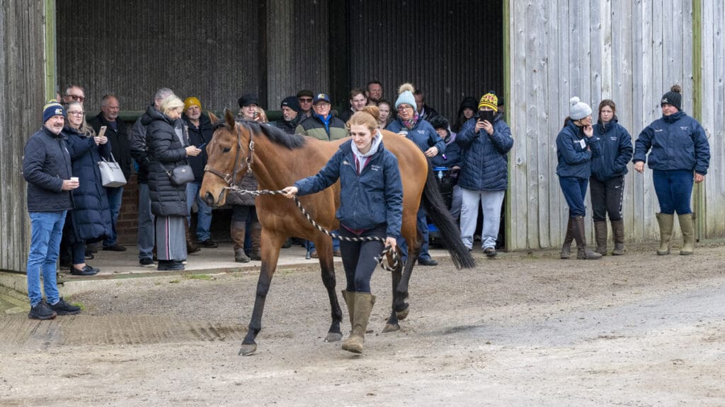 Ruth talks to the members, explaining the yard's daily routines