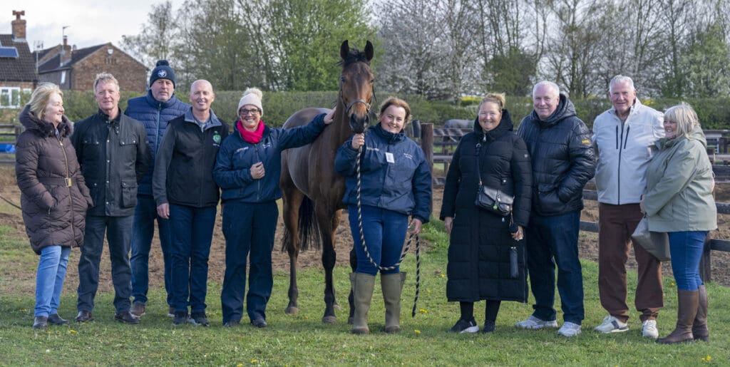 Palmarian poses with owners of the MDP Racing