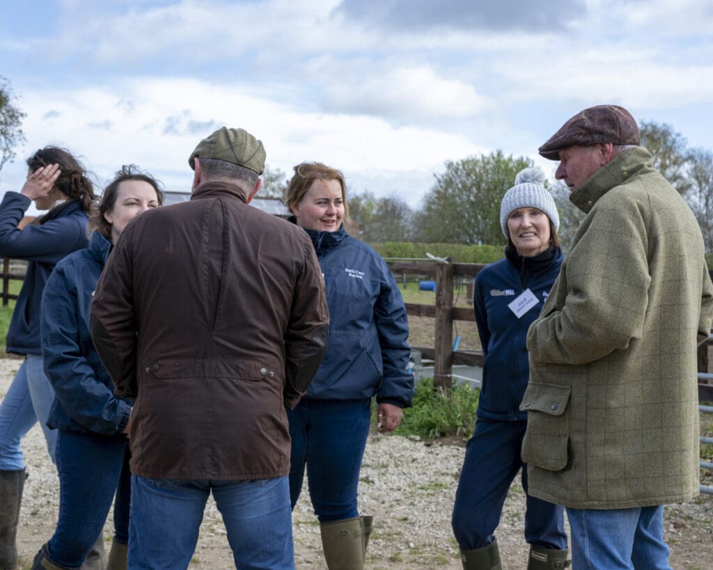 The team members chat amongst the visitors